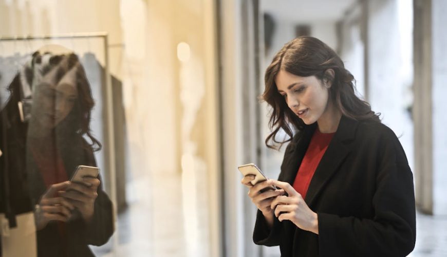 Close-up Photo of Woman in Black Coat Using Smartphone